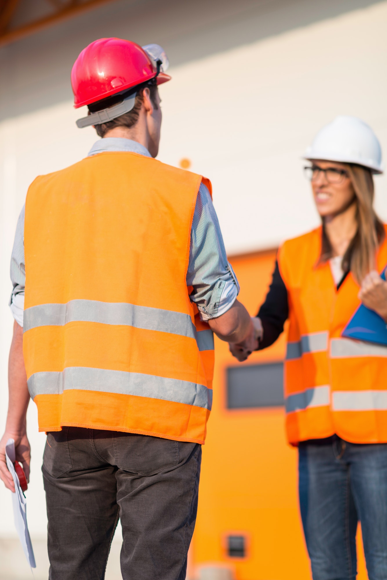 Business handshake on construction site